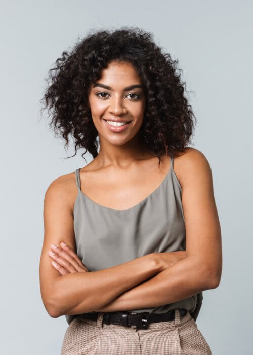 Content woman stands, arms crossed